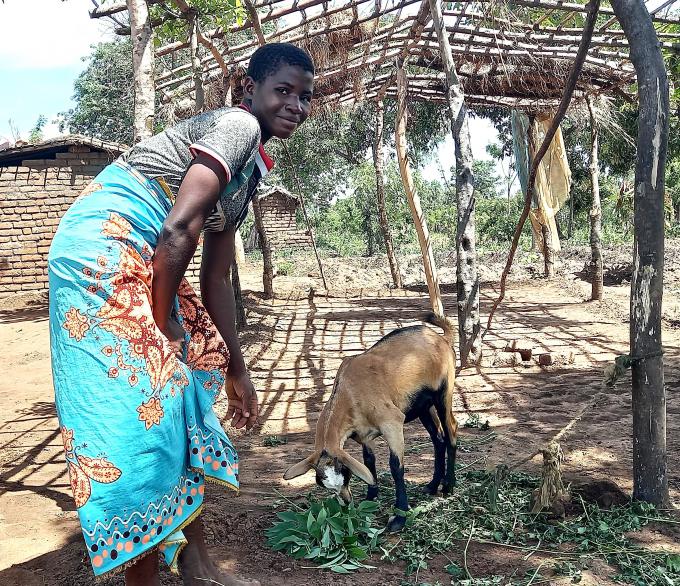 Effeta proudly stands beside one of her goats—a symbol of hope and empowerment. With the support of Save the Children's RED Project, Effeta is overcoming the challenges of climate change, ensuring food security and a brighter future for her family.