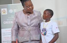 Minister of Gender, Hon. Jean Sendeza, embraces 12-year-old Bridget after her powerful speech at the Children's Climate Justice Summit, offering words of support and encouragement in the wake of Bridget’s personal story of resilience.